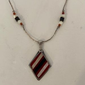 Z49 Necklace with a red, white, and black pendent.